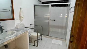 A bathroom with a sink, toilet, and shower.