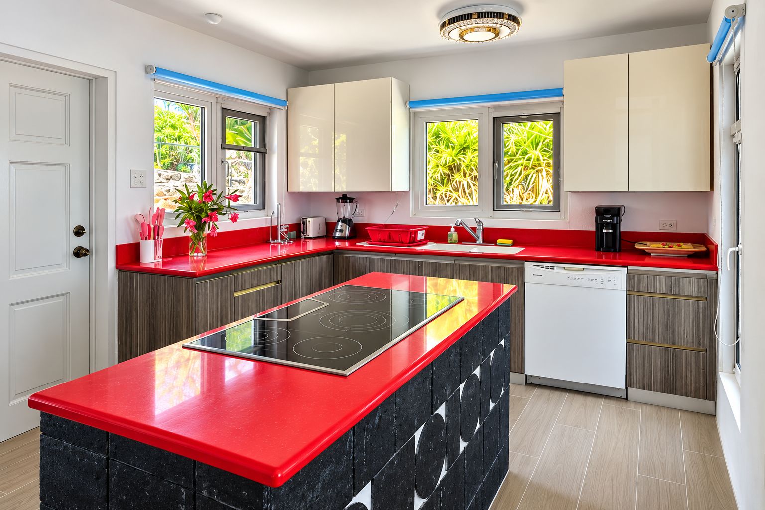 A modern kitchen with a central island, built-in appliances, and a red countertop.