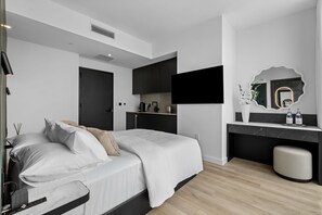 A modern bedroom with a bed, bedside table, and a built-in desk with a mirror. - 26th Floor E11EVEN Retreat with Skyline & Bay Views (Miami)
