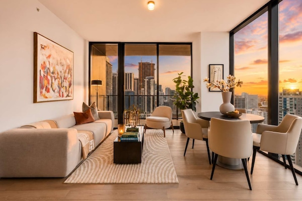 Living room overlooking the city at sunset.