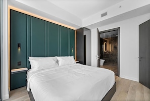 Bed with white linens and a green paneled headboard. - 23rd Floor E11EVEN 1BR with Balcony & Views (Miami)