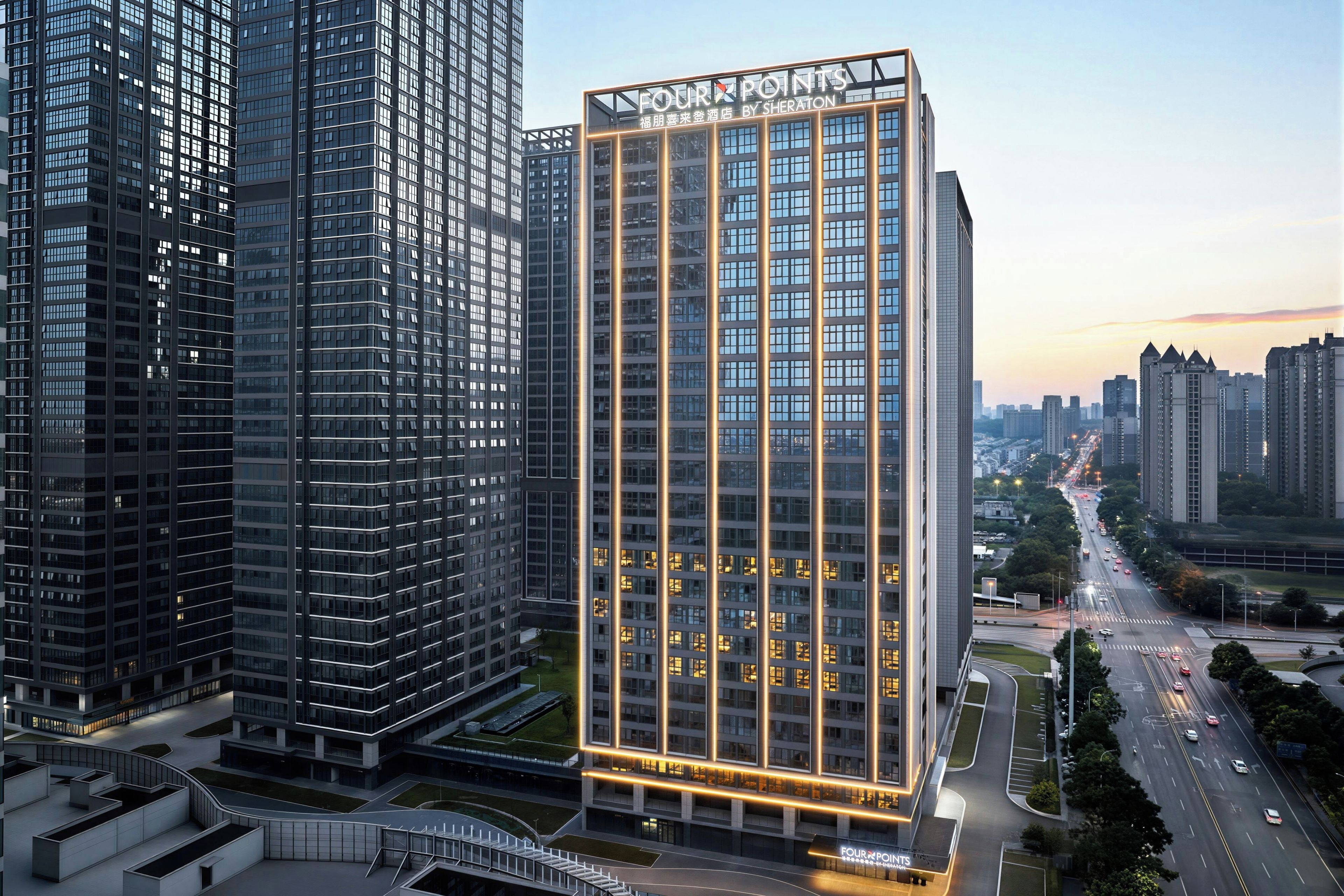 A high-rise hotel with a prominent sign, surrounded by other tall buildings.