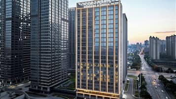 A high-rise hotel with a prominent sign, surrounded by other tall buildings.
