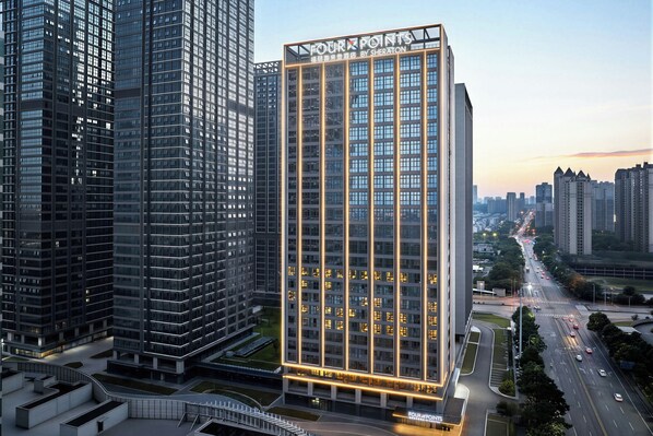 A high-rise hotel with a prominent sign, surrounded by other tall buildings. - Four Points By Sheraton Changsha South Station (Changsha)