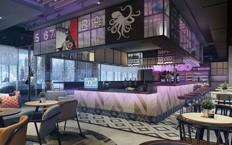 A modern bar area with a sushi menu, a check-in/out sign, and a neon sign.