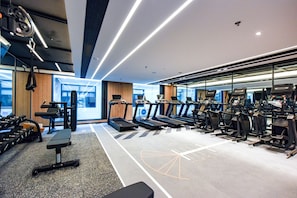 A modern gym with treadmills, weights, and a mirrored wall. - Four Points By Sheraton Zhangjiajie National Forest Park (Zhangjiajie)