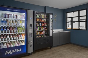 A vending machine area with a water dispenser and a snack vending machine.