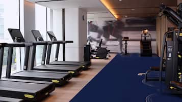 A gym with treadmills, exercise bikes, and weight machines.