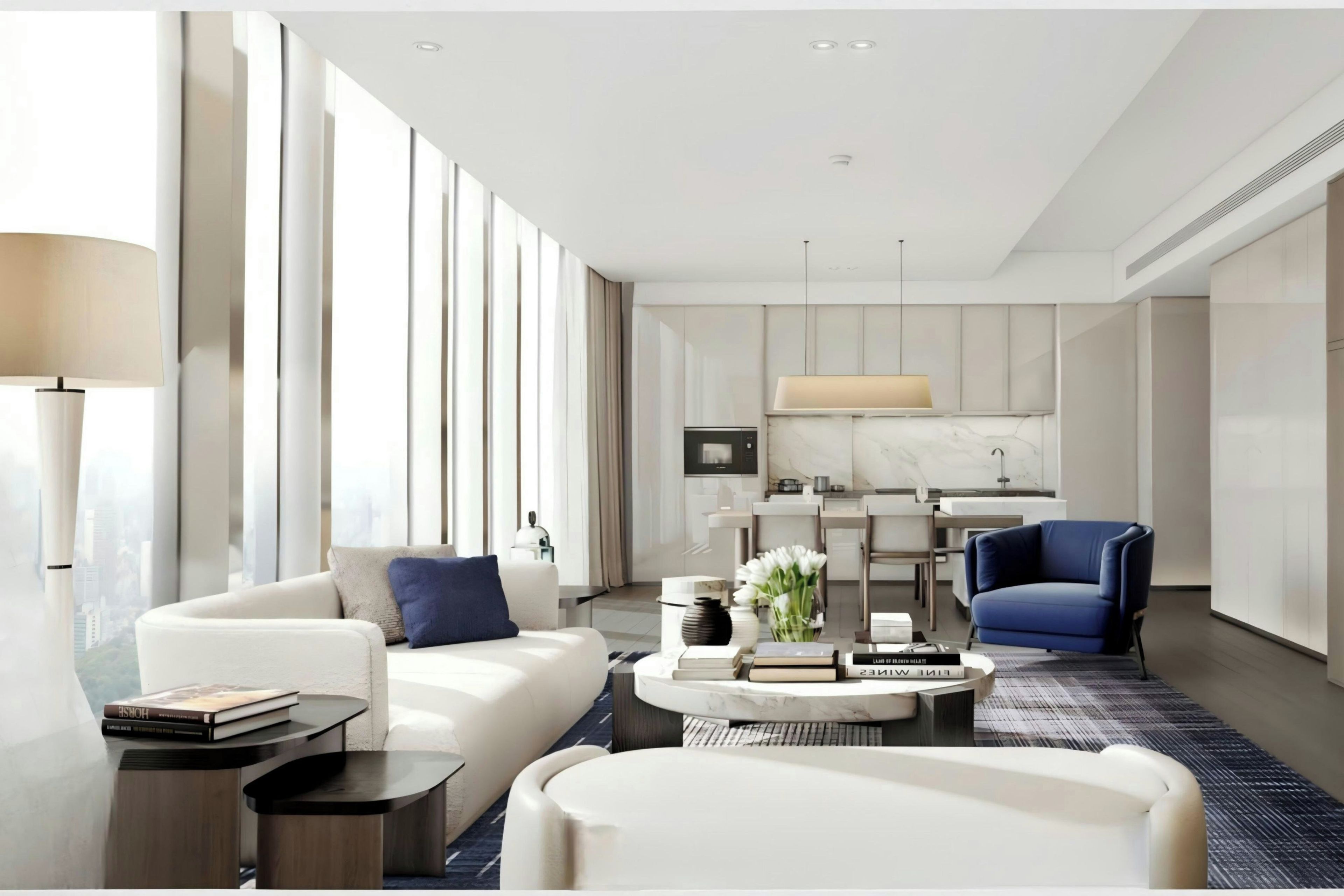 A modern hotel room with a living area, a dining area, and a kitchen.