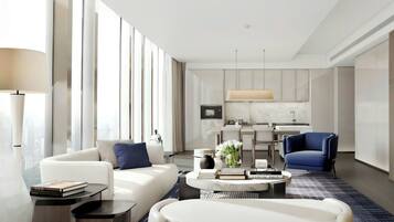A modern hotel room with a living area, a dining area, and a kitchen.