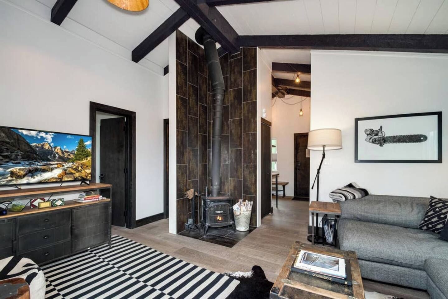 A living room with a fireplace, a television, and a sofa.