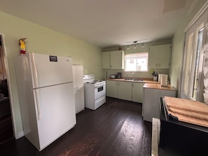 A compact kitchen with a refrigerator, stove, and sink. - Large Verandah, lake views, 4 bedroom historic cottage, the Annex. Clyffe House (Port Sydney)