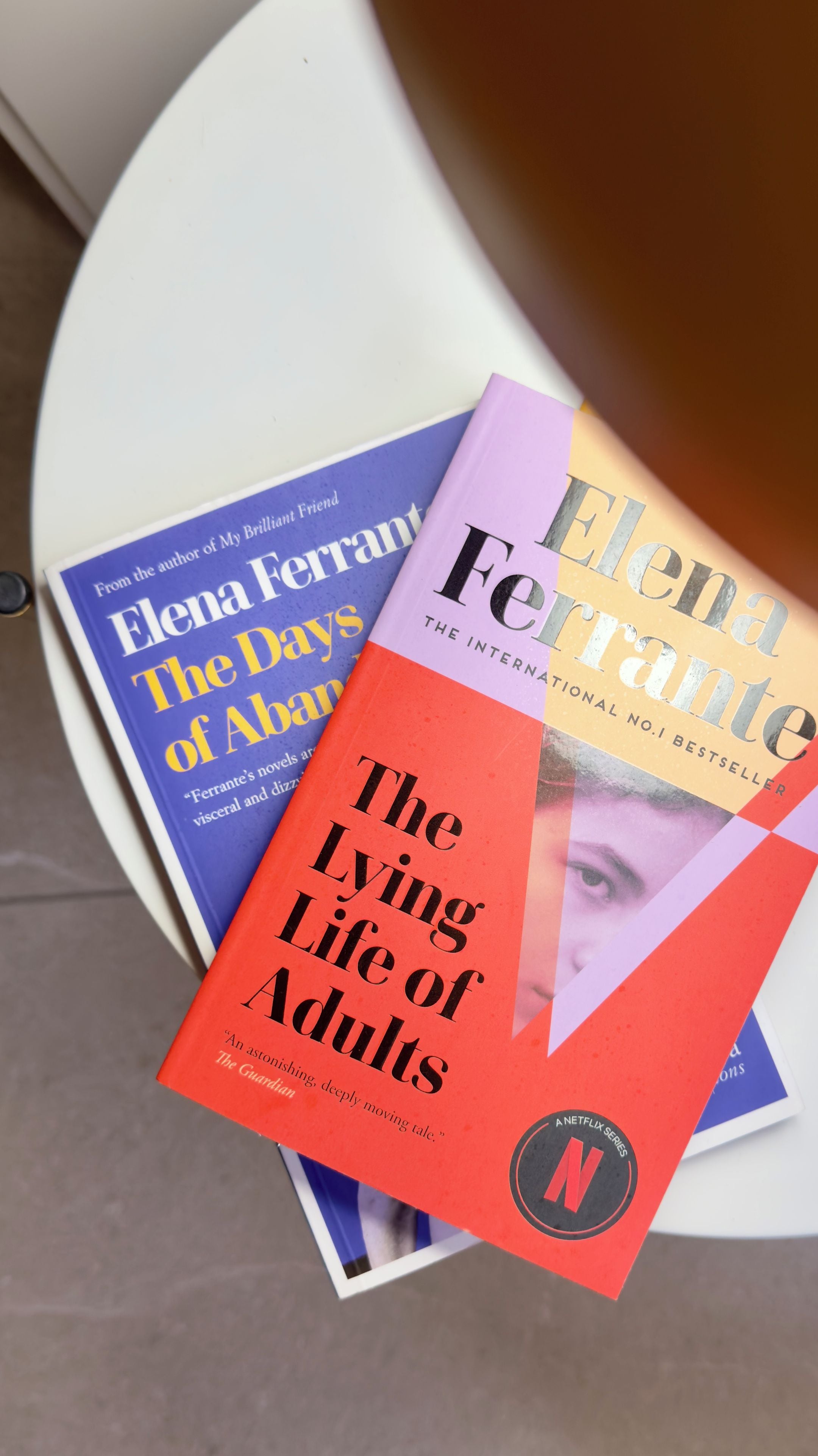A stack of books with visible titles and one marked as an international bestseller.