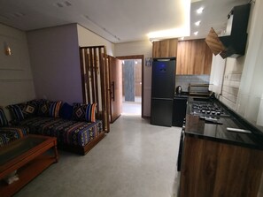 A modern kitchen with a built-in stove and a refrigerator. - 🌊 New studio apartment in Martil • Self-Check-in • Secure residential complex (Martil)