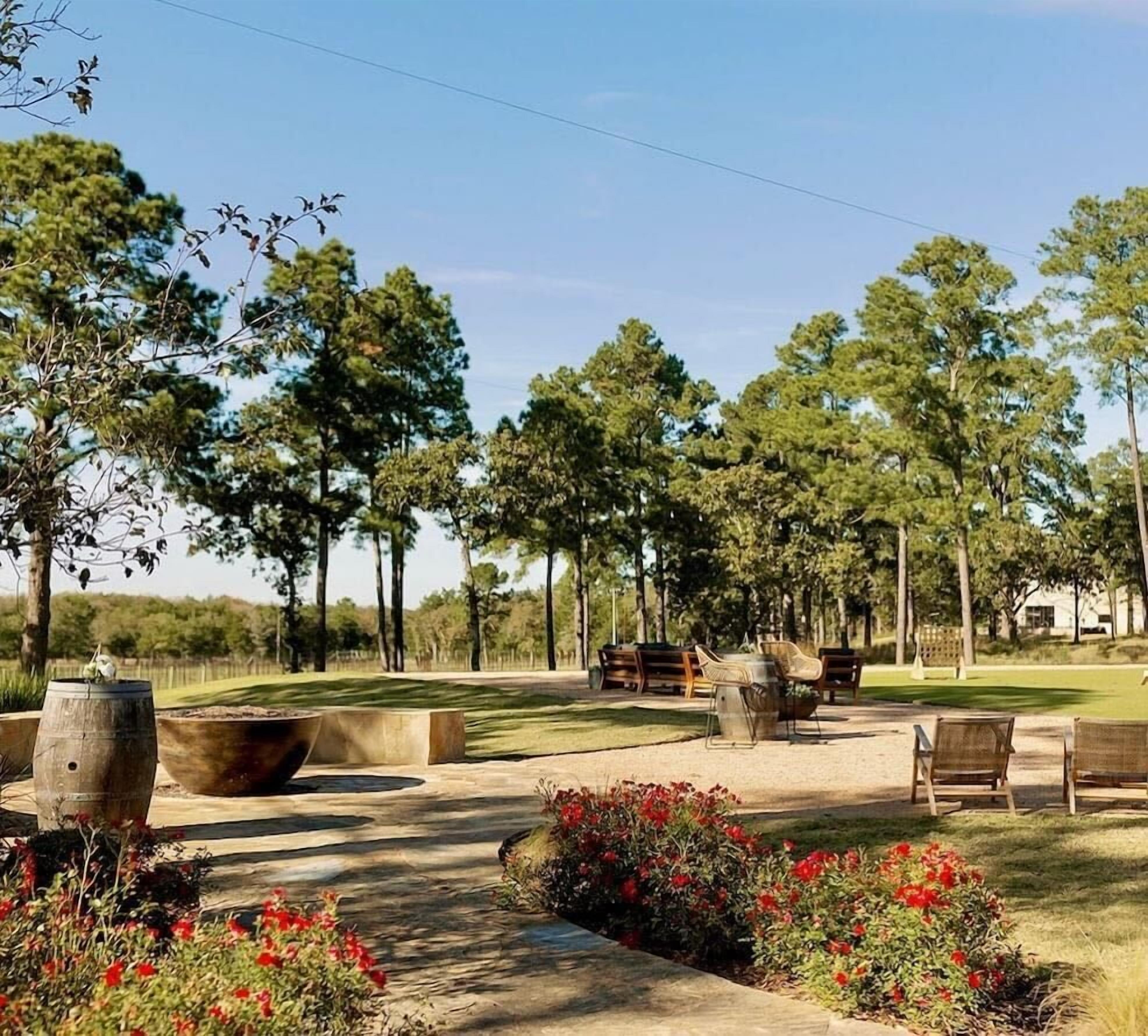 An outdoor patio area with seating, planters, and a fire pit.