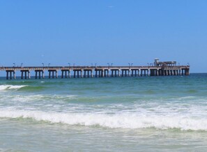 A pier extending into the water with a clear sky above. - Gulf Shores Escape with Breathtaking Views, Beach Days & Unforgettable memories (Gulf Shores)