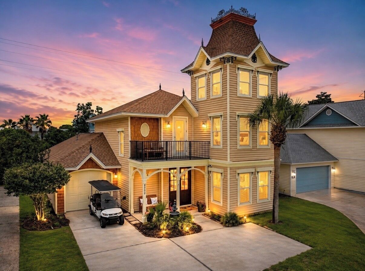 A two-story house with a garage, a covered porch, and a driveway.