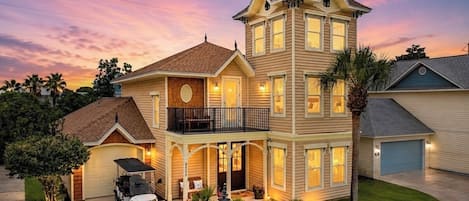 A two-story house with a garage, a covered porch, and a driveway.