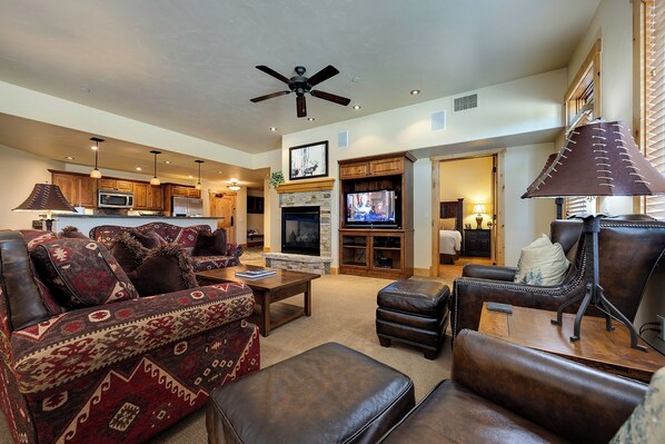 A spacious living room with a fireplace, leather furniture, and a television. - BL6101 | Air Chilling | 4 Pools | 10 Hot Tubs | Winter Shuttle | Close to Slopes (Steamboat Springs)