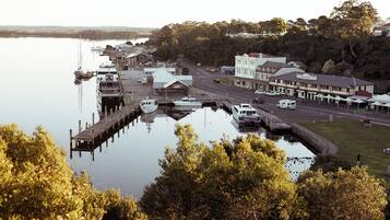 A riverside town with a dock, buildings, and a road.