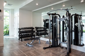 A gym with exercise equipment, a bench, and a rack of dumbbells. - Luxury Wellness Focused Bayfront Retreat with Saltwater Pool (Clearwater)