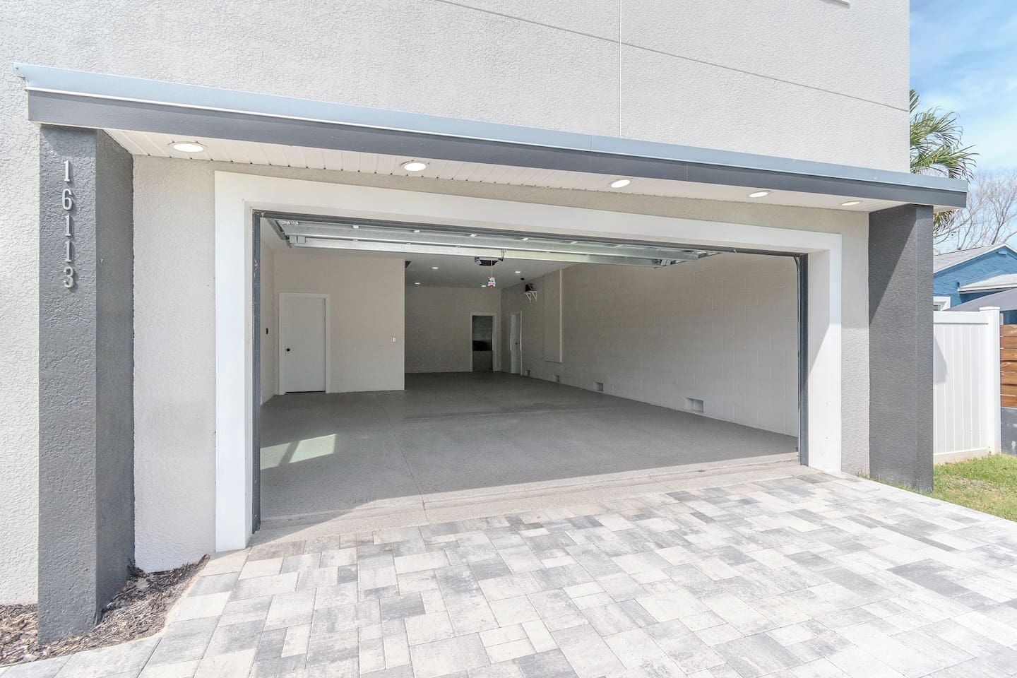 A modern garage with a flat roof and a covered entrance.
