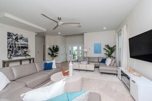 A modern living room with a sofa, coffee table, and TV.