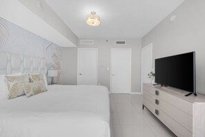 A modern bedroom with a large bed, a flat-screen TV, and a minimalist design. - ICON BRICKELL IMPRESSIVE 5★ OCEAN/POOL VIEWS @45th (Miami)
