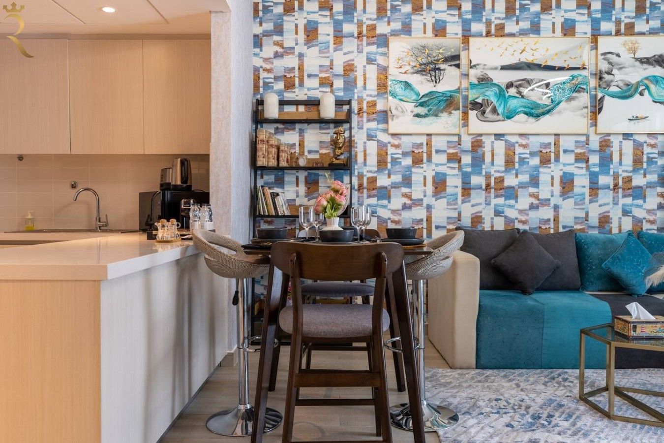 A modern kitchen with a dining area, a sofa, and a coffee table.