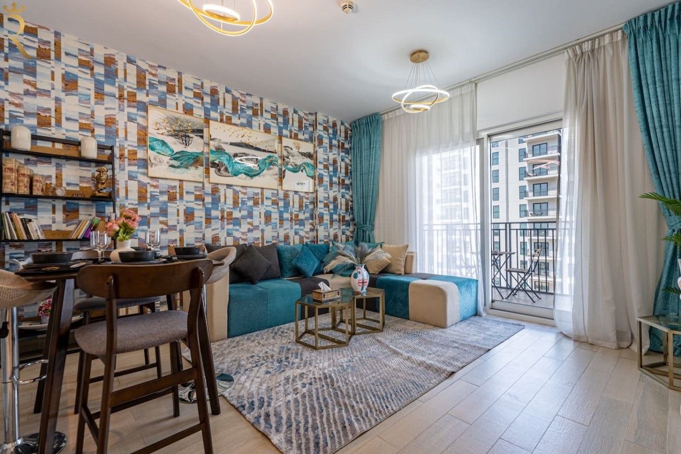 A modern living room with a sofa, dining table, chairs, and a balcony with a view.