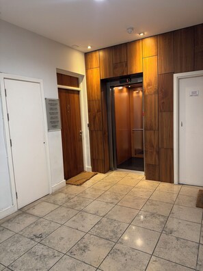An elevator with a digital display, a sign indicating entrance to the fourth floor, and a smoke vent sign. - Dublin City Centre Spacious yet Cosy 2B in the Heart of Historic Dublin (Dublin)