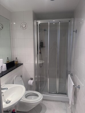A modern bathroom with a glass-enclosed shower, a white toilet, and a sink with a mirror above it. - Spacious Dublin City Centre 2 Apartment w/Gym on site. (Dublin)