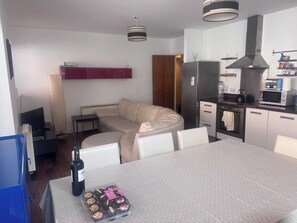 A modern kitchen with a dining area, a sofa, and a TV. - Spacious Dublin City Centre 2 Apartment w/Gym on site. (Dublin)