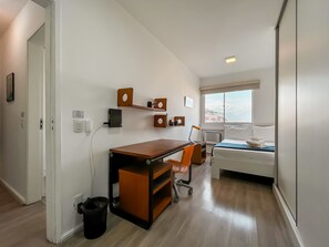 A compact bedroom with a bed, a desk, and a chair. - 2BR Apt Just 10 Mins From Barra da Tijuca Beach Vlm905 (Rio de Janeiro)