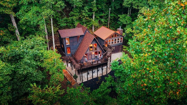 A cabin with a wooden deck and a small staircase leading to the entrance. - RRG cottage - cave fire pit, hot tub, & pool table (Stanton)