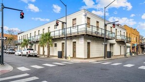 A building with a flat facade, multiple windows, and a balcony.