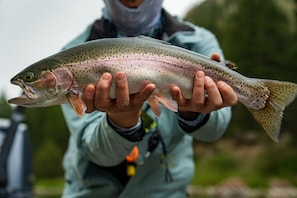 A person holding a fish.