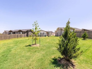 A residential area with multiple houses, a fenced yard, and small trees. - 1 -3-bedroom Single Family Residence house in perfect Oklahoma City (Oklahoma City)