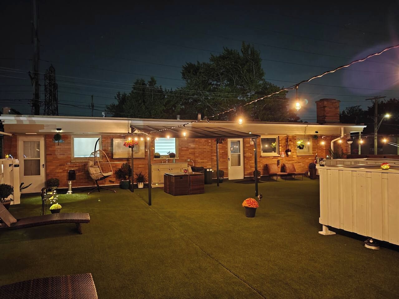 A backyard with a barbecue area, outdoor seating, and a pool.
