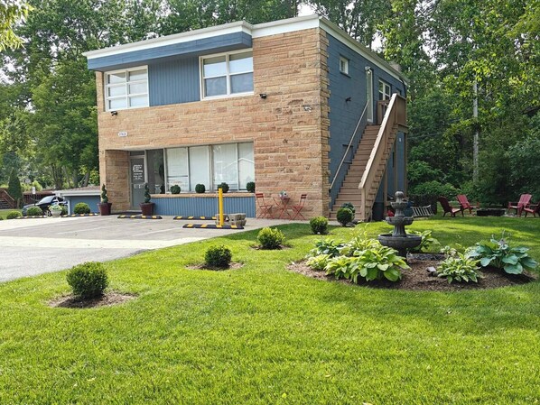 A two-story building with a brick facade and a blue upper section.