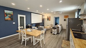 A modern living space with a dining area, kitchen, and seating area. - The Modern Loft & Patio (Waukegan)