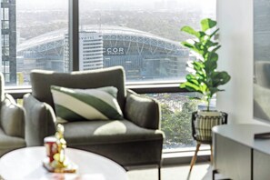 A modern living room with a view of a stadium.