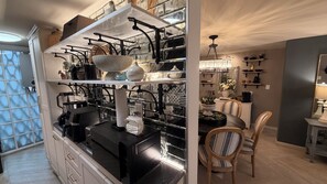 A kitchen with modern appliances, a dining area with chairs, and a decorative vase on the table. - Beautiful, Cozy, and Quiet Apartment in Coyoacán, Mexico City (Ciudad de México)