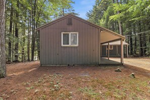 A small wooden cabin with a single window and a covered porch area. - Center Harbor Lake Escape | Private Dock (Center Harbor)