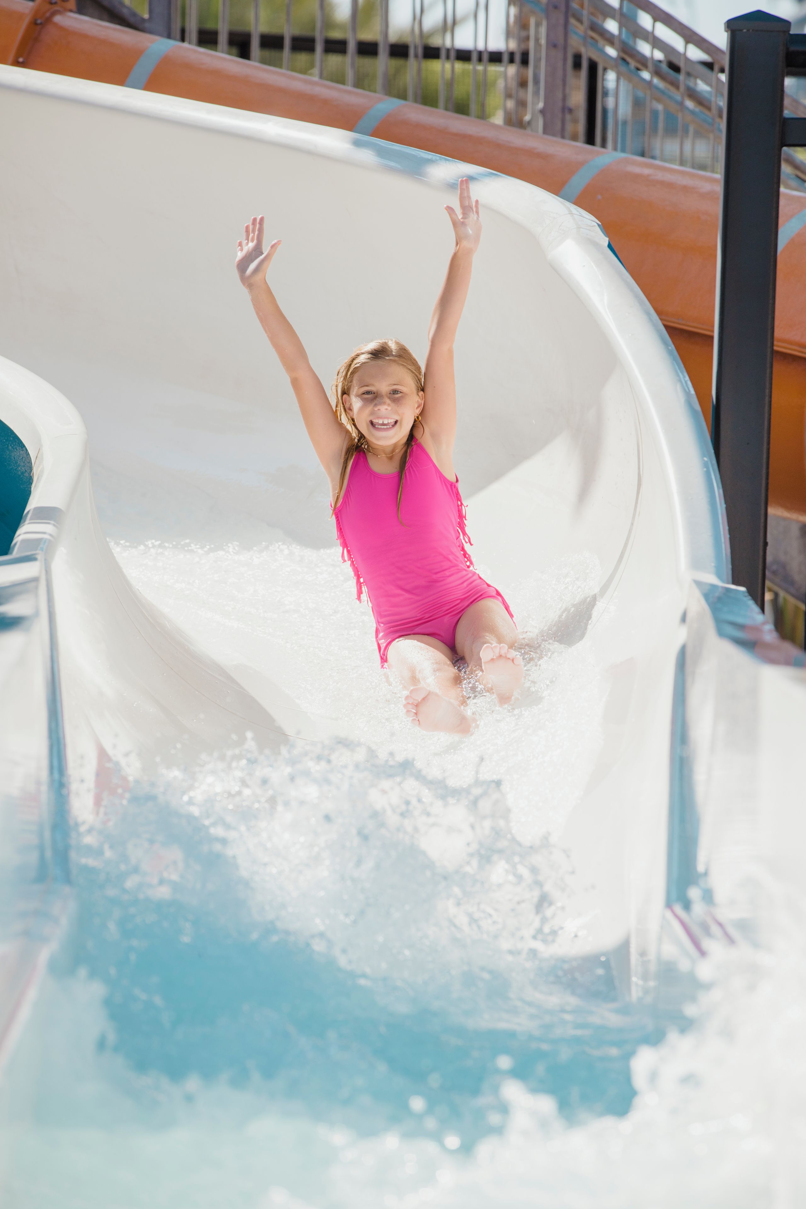 A person sliding down a water slide.