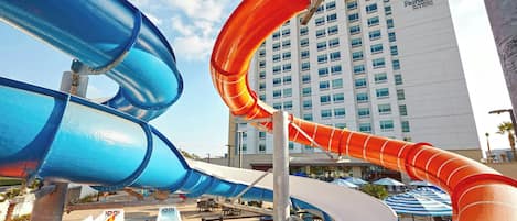 A water park with multiple slides and a Marriott hotel in the background.