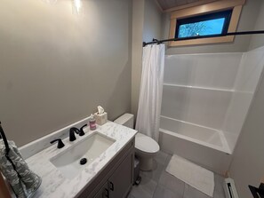 A bathroom with a sink, toilet, and shower area. - Shark Belly Mountain Chalet - the Ultimate Lux Mountain Retreat (Bethel)