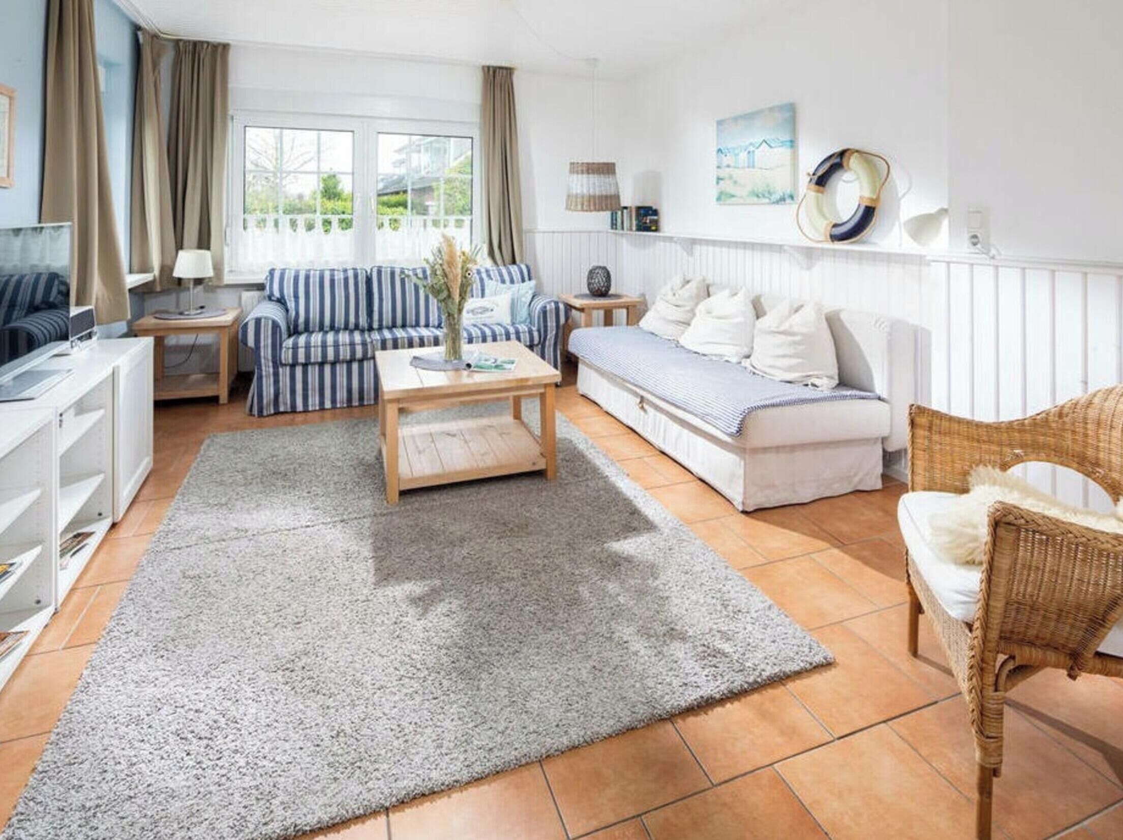 A modern living room with a sofa, a coffee table, and a television.