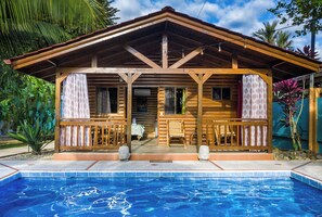 A wooden cabin with a pool in front. - Tropical Paradise w/ 2 Sapacious Cabinas AC & Pool (Playa Herradura)