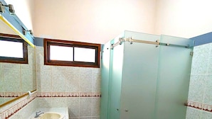 A bathroom with two sinks, a toilet, and a glass shower enclosure. - Stylish & Cozy Private Rooms in Tropical Paradise (Playa Herradura)